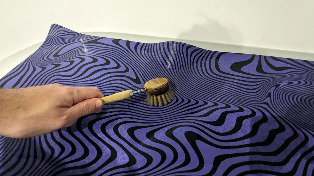 How to clean a Desk Mat with brush